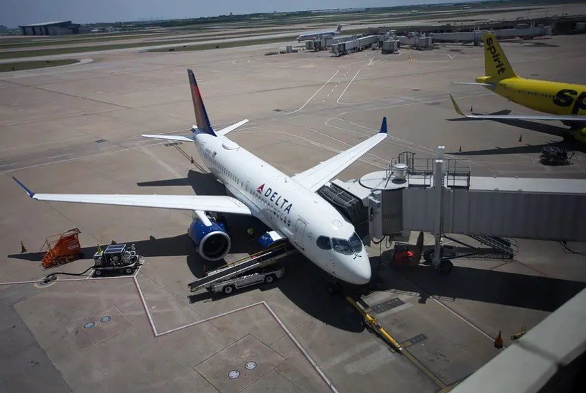 A Delta Air Lines Airbus A220 jet waits between flights at Dallas/Fort Worth International Airport.
